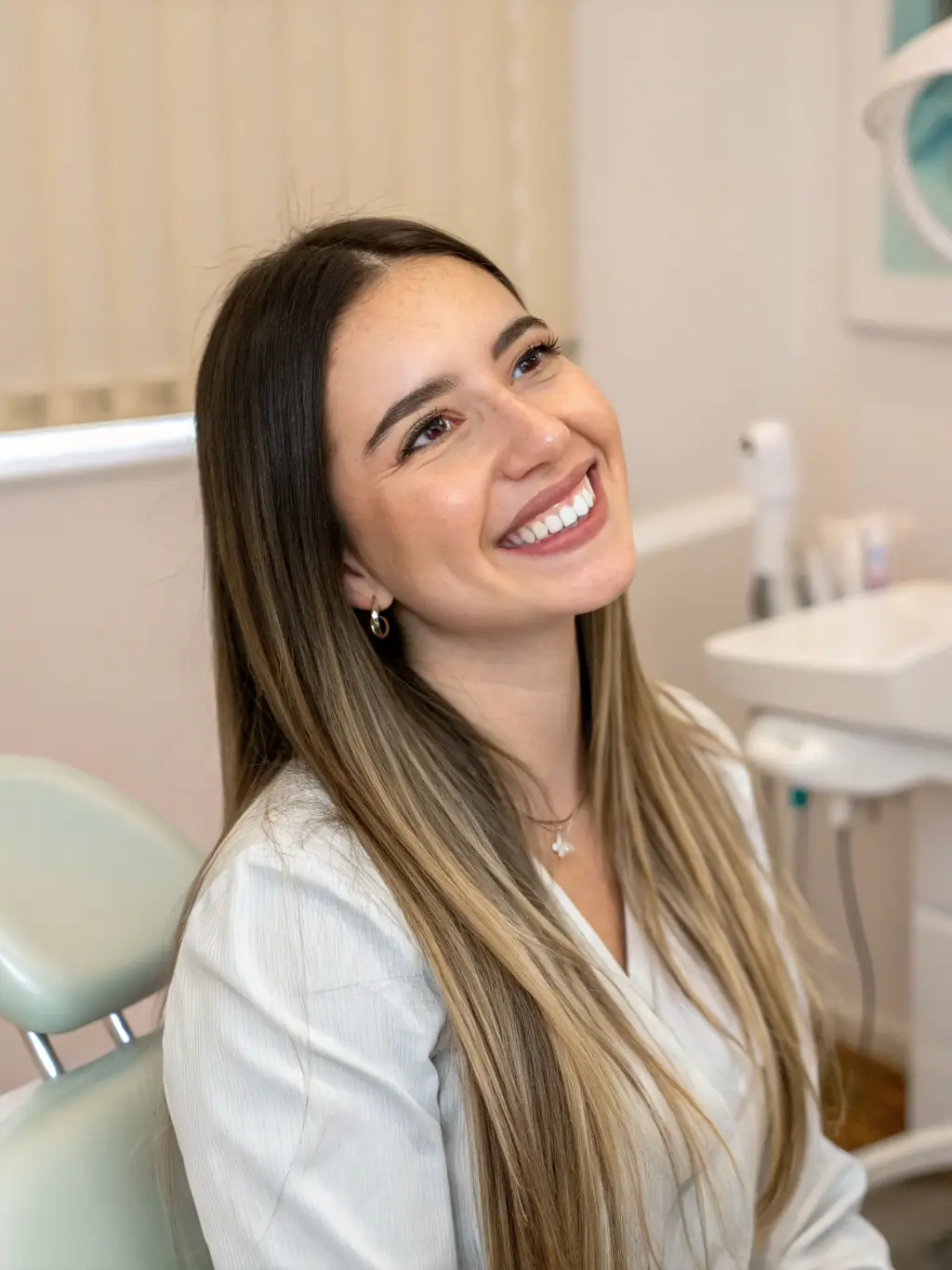 A patient smiling confidently after a teeth whitening procedure, highlighting the clinic's cosmetic dentistry services.